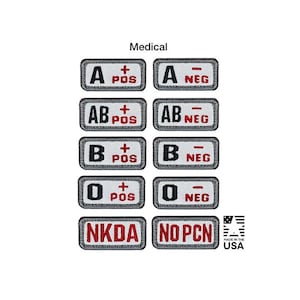 May include: A collection of rectangular embroidered patches featuring blood types A, AB, B, and O in positive and negative variations, plus NKDA and NO PCN labels. Each patch has a gray border, white background, and black or red text.