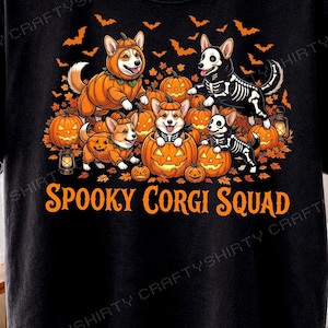 May include: A black t-shirt featuring a graphic of Corgi dogs dressed in Halloween costumes, including pumpkin suits and skeleton outfits, surrounded by jack-o'-lanterns, autumn leaves, bats, and lanterns, with the text SPOOKY CORGI SQUAD below.
