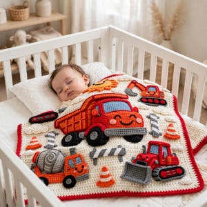 May include: A cream-colored crochet baby blanket featuring appliqued construction vehicles including a red dump truck, an orange cement mixer, and a red bulldozer, along with orange traffic cones, a yellow sun, and gray barriers.
