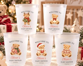 May include: Five frosted plastic cups featuring illustrations of teddy bears in winter clothing. Each cup displays the text Welcome to Oliver's Baby Shower 09.05.2026. The bears are depicted wearing items like scarves, sweaters, and a Santa hat.