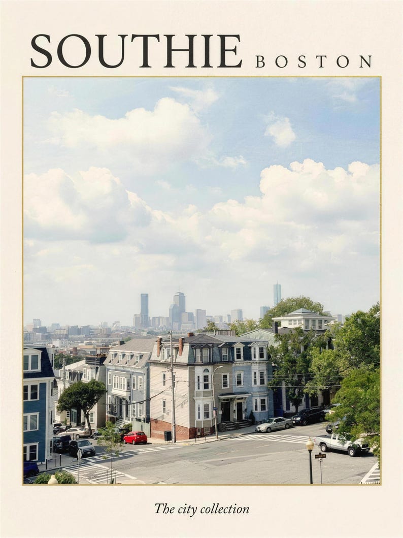 May include: A print featuring the text SOUTHIE BOSTON at the top and The city collection at the bottom. The image shows a street scene with multi-story residential buildings, a road intersection, and a distant city skyline under a cloudy sky.