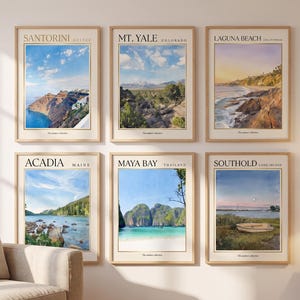 May include: Six framed wall art prints featuring landscape illustrations of Santorini, Mt. Yale, Laguna Beach, Acadia, Maya Bay, and Southold. Each print includes the location name, region, and the text The summer collection in a light wood frame.