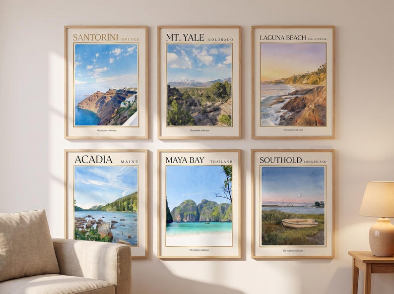 May include: Six framed wall art prints featuring landscape illustrations of Santorini, Mt. Yale, Laguna Beach, Acadia, Maya Bay, and Southold. Each print includes the location name, region, and the text The summer collection in a light wood frame.