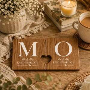May include: Two rectangular wooden coasters featuring the white printed letters M and O, with the text Mr & Mrs KNIGHTSBRIDGE below each letter. A heart-shaped cutout is positioned between the two coasters, which are made of light brown wood.