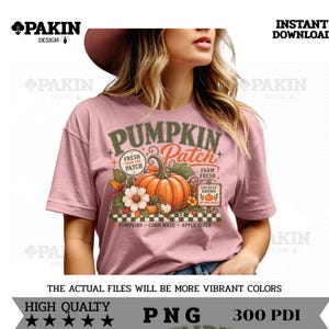 May include: A dusty pink t-shirt featuring a graphic print with the text PUMPKIN PATCH, FRESH FROM THE PATCH, FARM FRESH, LOCALLY GROWN, AUTUMN PICKED, PUMPKINS, CORN MAZE, and APPLE CIDER, alongside illustrations of a large orange pumpkin and flowers.