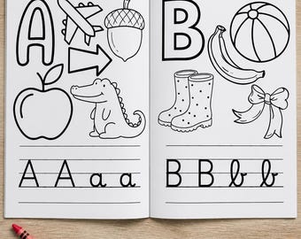 May include: An open coloring book featuring the letters A and B with black and white line drawings of an airplane, acorn, arrow, apple, alligator, ball, banana, boots, and bow, accompanied by four crayons in blue, red, green, and orange.