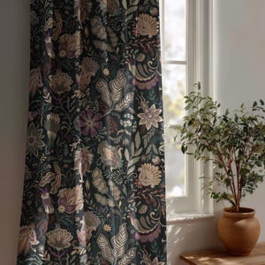 May include: A floor-length curtain panel featuring a dark charcoal background with a dense, repeating botanical pattern of stylized flowers and leaves in muted shades of beige, sage green, dusty purple, and deep brown, hanging near a window.