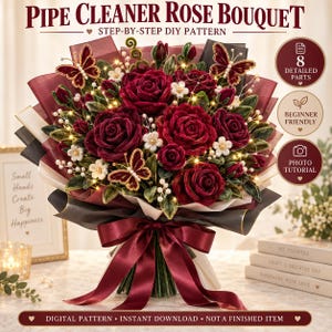 May include: A bouquet of deep red pipe cleaner roses with green leaves, small white flowers, and three butterfly accents. The arrangement is wrapped in dark burgundy and black paper with a large satin ribbon bow and illuminated by string lights.