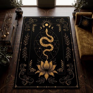May include: A rectangular area rug featuring a black background with gold-coloured line art. The design includes a central snake coiled above a large lotus flower, surrounded by geometric shapes, moon phases, and decorative floral scrollwork borders.