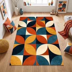 May include: A rectangular area rug featuring a repeating geometric pattern of overlapping circles and squares in a palette of deep blue, burnt orange, mustard yellow, and cream. The design consists of symmetrical curved shapes arranged in a grid.