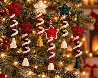 May include: Six crocheted star ornaments hanging from a tree. Each star features a spiral tail in red, white, and green, finished with a small tassel. The stars are solid red, white, or dark green, suspended by matching yarn loops.