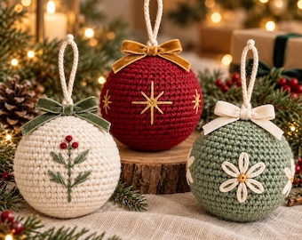 May include: Three spherical crochet ornaments with hanging loops. The left is cream with a green leaf and red berry embroidery. The center is dark red with gold star embroidery and a velvet bow. The right is sage green with white flower embroidery.