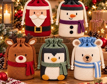 May include: Five cylindrical crochet drawstring bags featuring holiday characters: a red Santa Claus, a white snowman with a purple scarf, a brown reindeer with antlers, a black and white penguin with a green scarf, and a white bear with a blue scarf.