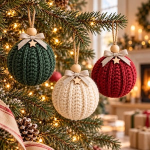 May include: Three spherical Christmas ornaments with a ribbed crochet texture in dark green, cream, and deep red. Each ornament features a natural wooden bead, a beige fabric bow, and a small wooden star charm, suspended by a jute twine loop.