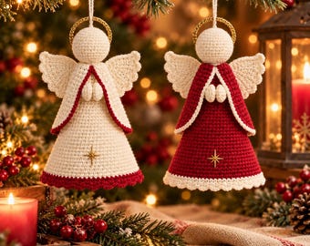 May include: Two crocheted angel ornaments hanging by white strings. One angel is cream with a red hem and a gold star, the other is red with a cream hem and a gold star. Both feature round heads, gold halos, and textured wings.
