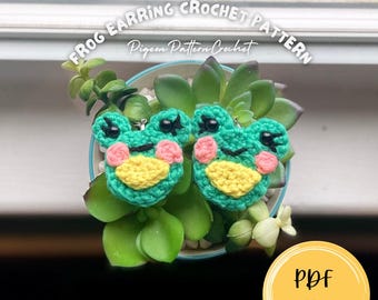 Puede incluir: Dos pequeños pendientes de rana de ganchillo verde con ojos negros con pestañas, mejillas rosadas y vientre amarillo. El texto FROG EARRING CROCHET PATTERN y Pigeon Pattern Crochet aparecen arriba, con un círculo amarillo PDF pattern abajo.