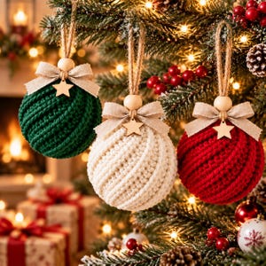 May include: Three spherical Christmas ornaments featuring a textured, diagonal knit pattern in dark green, cream, and red. Each ornament is topped with a beige fabric bow, a small wooden star, a round wooden bead, and a jute twine hanging loop.