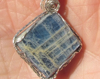 Polished Blue Kyanite , wire wrapped Pendant in sterling silver wire.