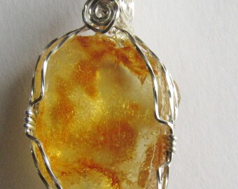 Amber pendant   in twisted  argentium silver wire.