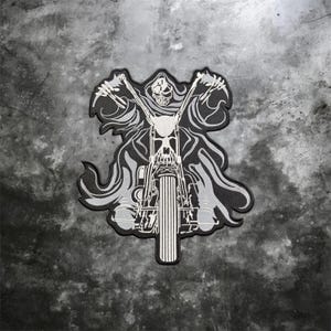 May include: A black and white embroidered patch featuring a hooded skeleton figure riding a motorcycle. The design shows the skeleton with arms outstretched, gripping the handlebars of a bike with a prominent front fork and tire in the center.