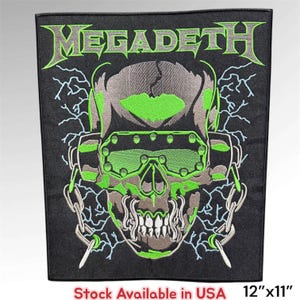 May include: A rectangular embroidered patch featuring the Megadeth logo in lime green and grey thread. The design depicts a skull wearing tactical goggles, surrounded by lightning bolts and chains on a black background, measuring 12 inches by 11 inches.