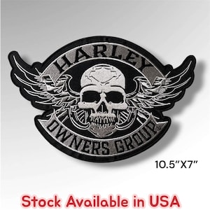 May include: A black and silver embroidered patch featuring a central skull design with wings. The text HARLEY is arched above the skull, and OWNERS GROUP is arched below. The patch measures 10.5 inches by 7 inches and is available in the USA.