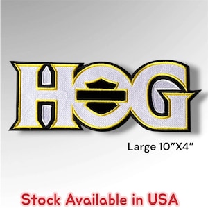 May include: An embroidered patch featuring the text HOG in white with black and yellow borders. The letter O incorporates a black shield emblem with a horizontal bar. The patch measures 10 inches by 4 inches as indicated by the text.