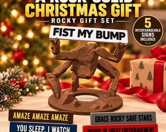 May include: A brown rock-like creature figurine standing on a circular base, holding a white sign that reads FIST MY BUMP. The set includes four additional rectangular signs with text: AMAZE AMAZE AMAZE, YOU SLEEP, I WATCH, GRACE ROCKY SAVE STARS, and WORDS OF GREAT ENCOURAGEMENT.