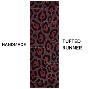 May include: A rectangular tufted runner rug featuring a repeating leopard print pattern in shades of deep burgundy, dark red, and black. The text HANDMADE and TUFTED RUNNER is visible on the sides of the rug, along with a watermark pattern.