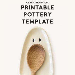 May include: A cream-coloured ceramic spoon rest shaped like a ghost with two small black dots for eyes. A wooden spoon rests inside the dish. The text CLAY LIBRARY CO. PRINTABLE POTTERY TEMPLATE is printed in black at the top of the image.