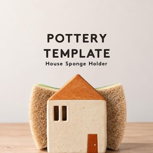 May include: A ceramic house-shaped sponge holder with a cream-coloured body, a brown roof, and a brown door. The text POTTERY TEMPLATE House Sponge Holder is printed above the object, which holds a textured, tan-coloured scrubbing sponge.