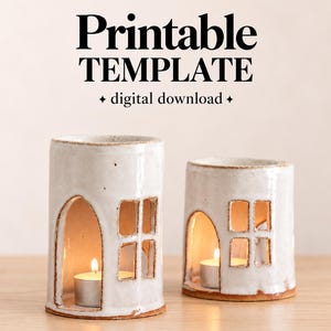 May include: Two white ceramic candle holders shaped like small houses with arched doorways and square windows. The text CLAY LIBRARY CO. Printable TEMPLATE digital download is visible above the objects, which contain lit tea light candles.
