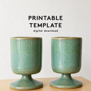 May include: Two identical ceramic goblets with a glossy, speckled seafoam green glaze and a wide, stable pedestal base. The text PRINTABLE TEMPLATE digital download appears above the goblets, and CLAY LIBRARY CO. is printed at the bottom.