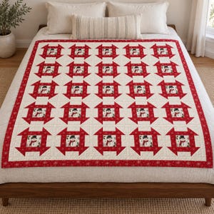 May include: A quilt featuring a repeating pattern of square blocks, each containing a central illustration of a snowman wearing a black top hat and red scarf, surrounded by red geometric borders on a cream background with snowflake motifs.