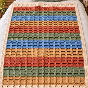 May include: A rectangular crochet blanket featuring horizontal stripes in alternating colors of cream, rust orange, sage green, and light blue. The blanket has a textured, open-work grid pattern throughout and is finished with a solid cream border.