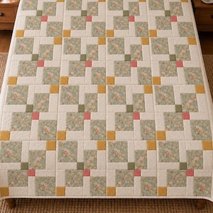May include: A rectangular quilt featuring a repeating block pattern of cream-colored fabric squares interspersed with floral-printed fabric in sage green, accented by small solid squares in mustard yellow, olive green, and coral pink.