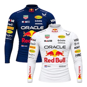 May include: Two long-sleeve mock neck shirts in dark blue and white, featuring Red Bull branding, Oracle text, and various sponsor logos including Mobil 1, TAG Heuer, Honda, and a small Dutch flag with the name MAX printed on the chest.