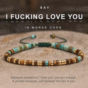 May include: A beaded bracelet featuring a mix of turquoise, brown tiger eye, and gold-toned cylindrical beads arranged in a Morse code pattern. The bracelet includes a dark green adjustable cord with a sliding knot closure and two small end beads.