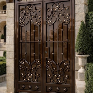 May include: A double gate made of dark brown metal featuring symmetrical scrollwork patterns, vertical bars, and small gold-colored accents. The gate is framed by two stone pillars and includes a central locking mechanism with a keyhole.