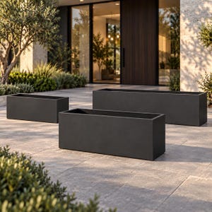 May include: Three rectangular planters in a matte charcoal finish. The set consists of one large, one medium, and one small container, each featuring clean, sharp edges and a hollow interior, designed for holding plants in an outdoor setting.