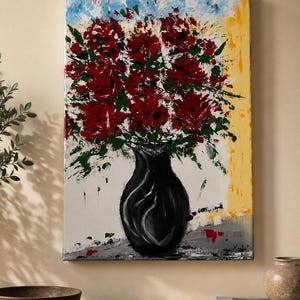 May include: A rectangular canvas painting featuring a black vase filled with vibrant red flowers and green foliage. The background displays abstract splashes of blue, yellow, and white paint, with a gray surface at the base of the vase.