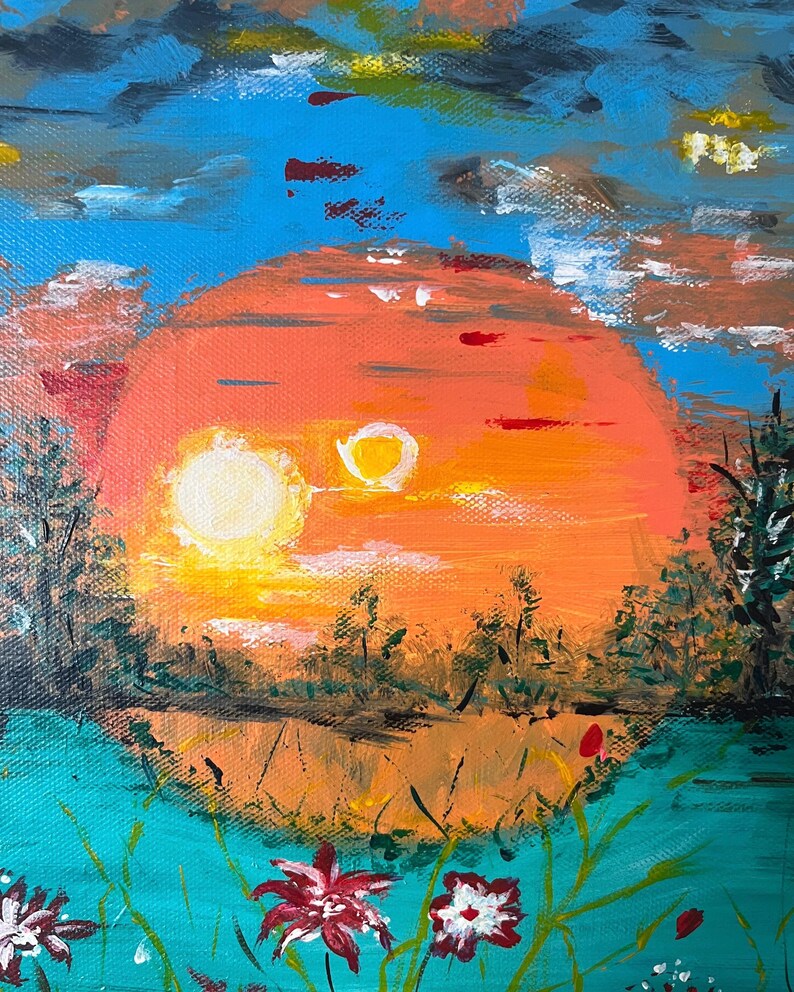 May include: An acrylic painting on canvas depicting a vibrant orange sun setting over a landscape with dark silhouettes of trees. The foreground features teal water with scattered red and white flowers. The sky is a mix of bright blue and dark clouds.
