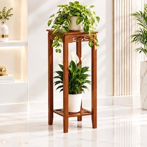 May include: A tall, square wooden plant stand with four legs and two tiers. The top tier holds a potted pothos plant, while the bottom tier holds a potted peace lily. The stand features a slatted, open-work design under the top surface.