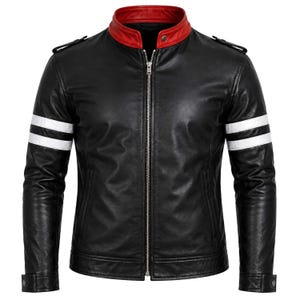 May include: A black jacket featuring a red mandarin collar, a full-length silver front zip, and two horizontal white stripes on each sleeve. The garment includes shoulder epaulettes and buttoned cuffs, presenting a structured design.