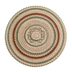 May include: A circular crochet doily featuring a central star-like motif surrounded by concentric rings in shades of cream, sage green, and terracotta. The intricate needlework includes various stitch patterns and a scalloped edge finish.