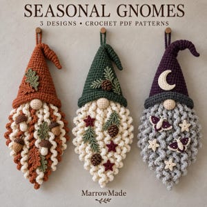 May include: Three hanging crochet gnome wall decorations with the text SEASONAL GNOMES 3 DESIGNS CROCHET PDF PATTERNS and MarrowMade. The left gnome has an orange hat with leaves and mushrooms, the centre has a green hat with pinecones, and the right has a purple hat with a moon, stars, and moths.
