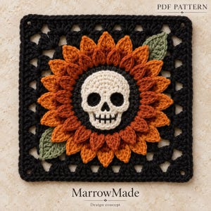 May include: A square crochet pattern featuring a central cream-colored skull surrounded by layered orange and rust-colored sunflower petals. The design is framed by a black border with two green leaves and includes the text PDF PATTERN MarrowMade.