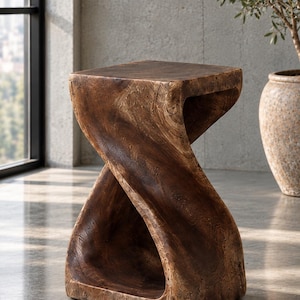 May include: A dark brown wooden stool with a distinct twisted, hourglass-like silhouette. The piece features a smooth, flat square top and a solid base, showcasing the natural grain and texture of the wood throughout its curved structure.