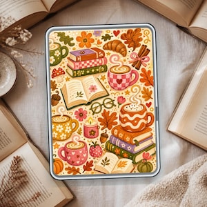 May include: A rectangular tablet screen displaying a colorful illustration of autumn-themed items including stacks of books, steaming mugs of coffee, croissants, cinnamon sticks, eyeglasses, candles, acorns, pumpkins, and various fall leaves.