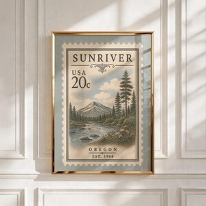 May include: A framed wall art print featuring a vintage-style postage stamp design. The graphic depicts a mountain landscape with a river, pine trees, and flowers. Text reads SUNRIVER, USA, 20c, OREGON, and EST. 1968 in a classic serif font.